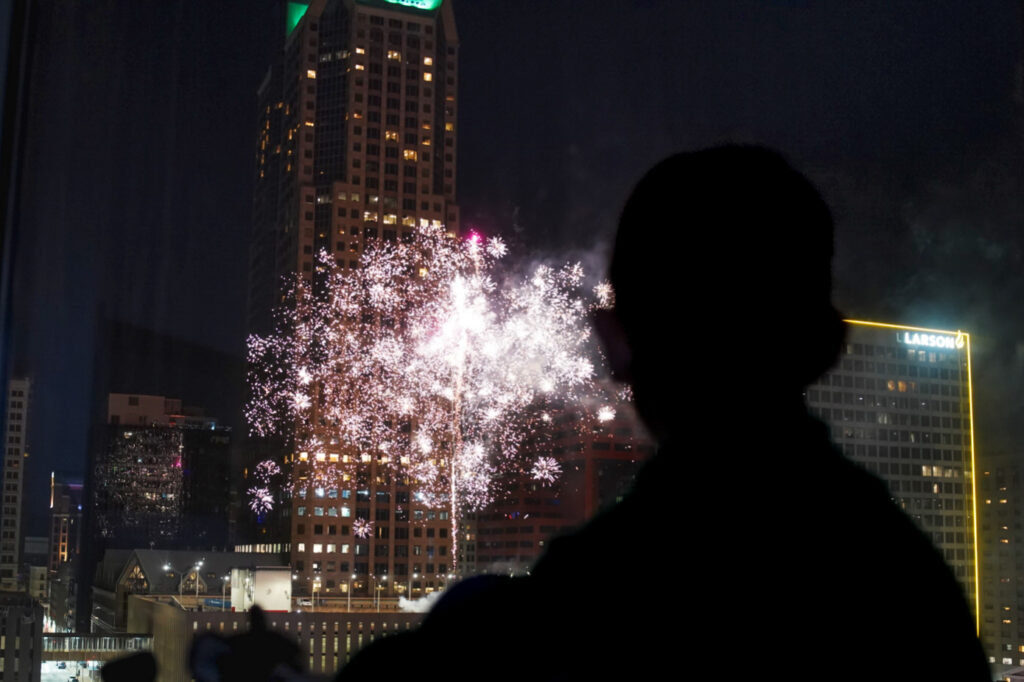 boy watching fireworks at night in downtown St. Louis