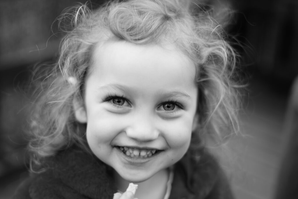 black and white photo of young girl with curls.